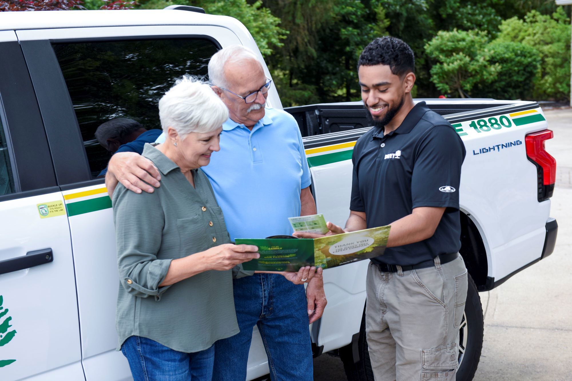 Employee and client in front of Ford Lightning