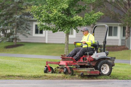 A man mowing a resident's lawn.