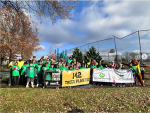 Volunteers pose with a banner