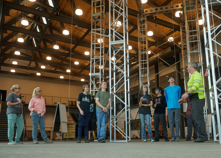 Skills trainer Rick Denbeau talks to a group in the Climbing Center