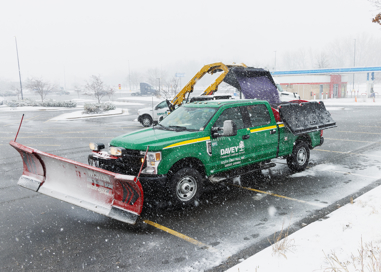 A Davey plow truck in a snowy parking lot.