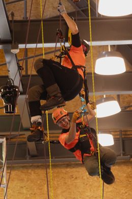 Two climbers compete in the head-to-head ascent event in Davey's climbing center