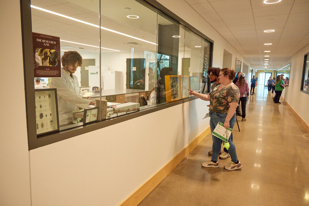 Employees look in laboratory space at SEED Campus