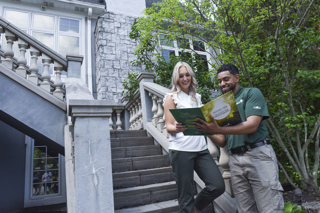 davey arborists speaks to a client on outdoor stairsteps
